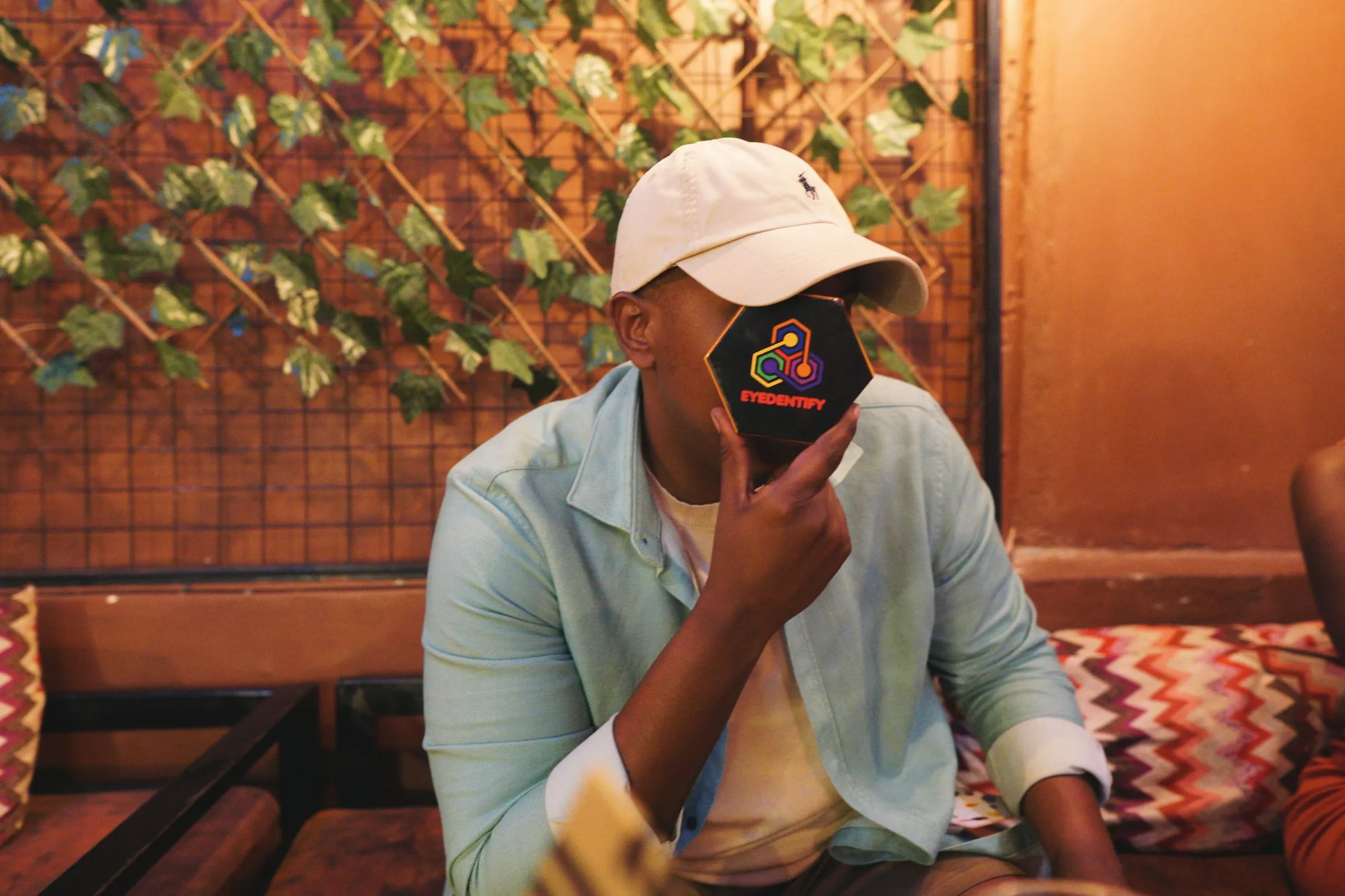 A player holding the Eyedentify tin up to his face